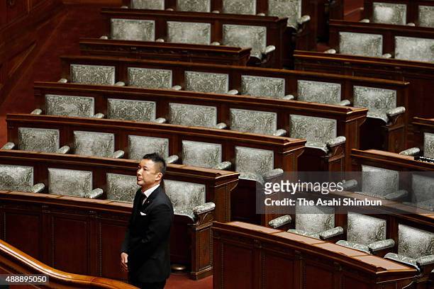 Upper house lawmaker Taro Yamamoto in mourning clothes votes in the sensure motion against Prime Minister Shinzo Abe during an Upper House plenary...