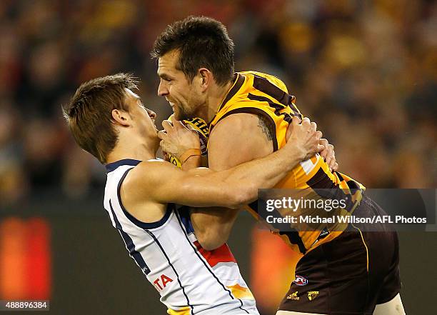 Luke Hodge of the Hawks is tackled by Jarryd Lyons of the Crows during the 2015 AFL Second Semi Final match between the Hawthorn Hawks and the...