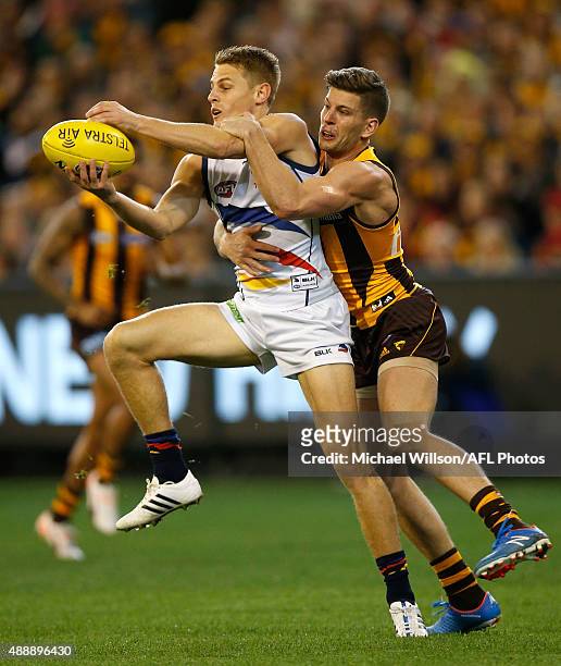 David Mackay of the Crows is tackled by Luke Breust of the Hawks during the 2015 AFL Second Semi Final match between the Hawthorn Hawks and the...