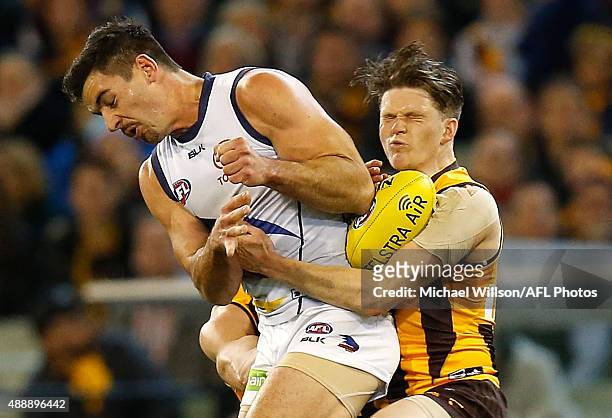 Taylor Duryea of the Hawks marks despite pressure from Taylor Walker of the Crows during the 2015 AFL Second Semi Final match between the Hawthorn...