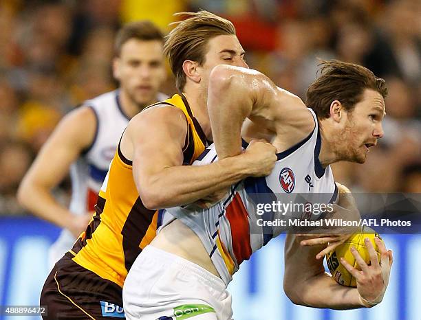 Patrick Dangerfield of the Crows is tackled by Ryan Schoenmakers of the Hawks during the 2015 AFL Second Semi Final match between the Hawthorn Hawks...