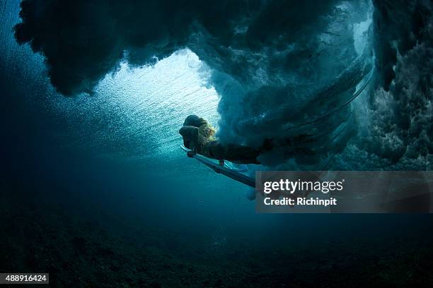 dark duck dive into the light - surfer wave stock pictures, royalty-free photos & images