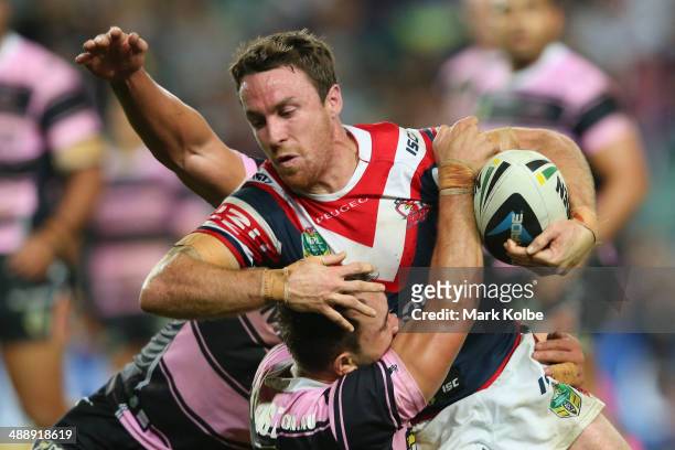James Maloney of the Roosters is tackled during the round nine NRL match between the Sydney Roosters and the Wests Tigers at Allianz Stadium on May...