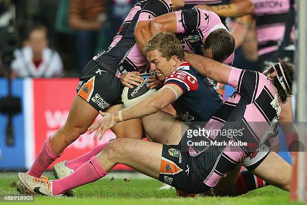 Mitchell Aubusson of the Roosters is tackled short of the line during the round nine NRL match between the Sydney Roosters and the Wests Tigers at...
