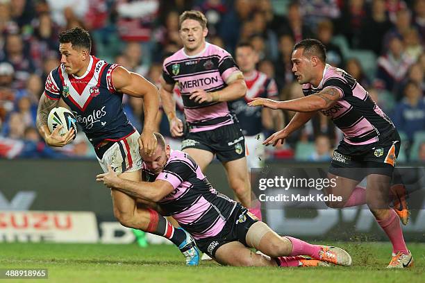 Sonny Bill Williams of the Roosters is tackled during the round nine NRL match between the Sydney Roosters and the Wests Tigers at Allianz Stadium on...