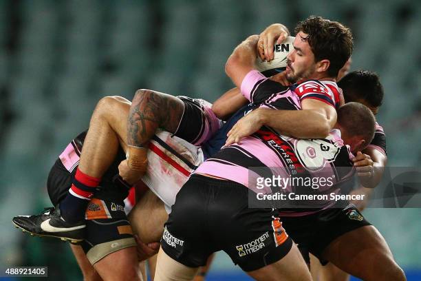 Aidan Guerra of the Roosters is tackled during the round nine NRL match between the Sydney Roosters and the Wests Tigers at Allianz Stadium on May 9,...