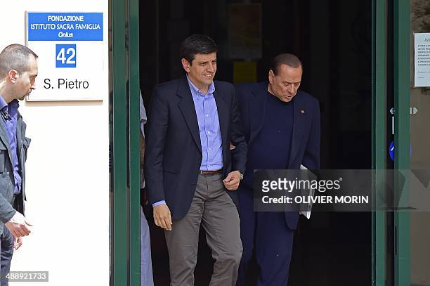 Italian former Prime Minister Silvio Berlusconi leaves the Catholic hospice "Sacra Famiglia" in Cesano Boscone after his first day of community...