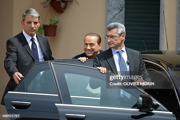 Italian former Prime Minister Silvio Berlusconi leaves the Catholic hospice "Sacra Famiglia" in Cesano Boscone after his first day of community...