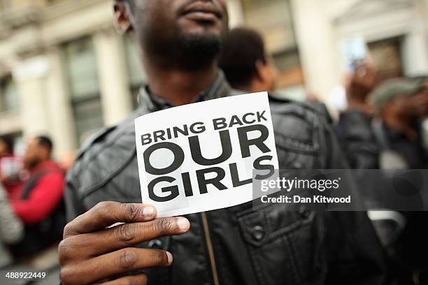 Man holds a sign that reads 'Bring back our girls' during a protest outside Nigeria House on May 9, 2014 in London, England. 276 schoolgirls were...