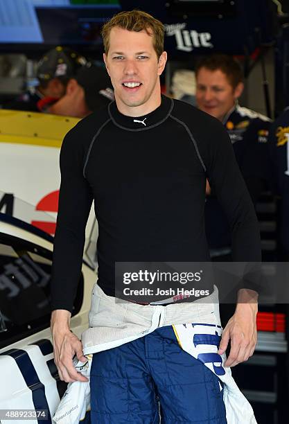 Brad Keselowski, driver of the Miller Lite Ford, stands in the garage area before practice for the NASCAR Sprint Cup Series myAFibRisk.com 400 at...