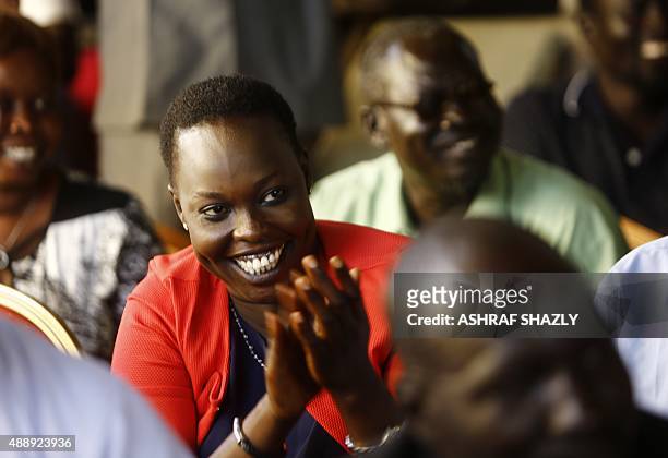 Displaced Sudanese woman who fled South Sudan claps during a meeting with South Sudan's former Vice President and rebel leader Riek Machar in the...
