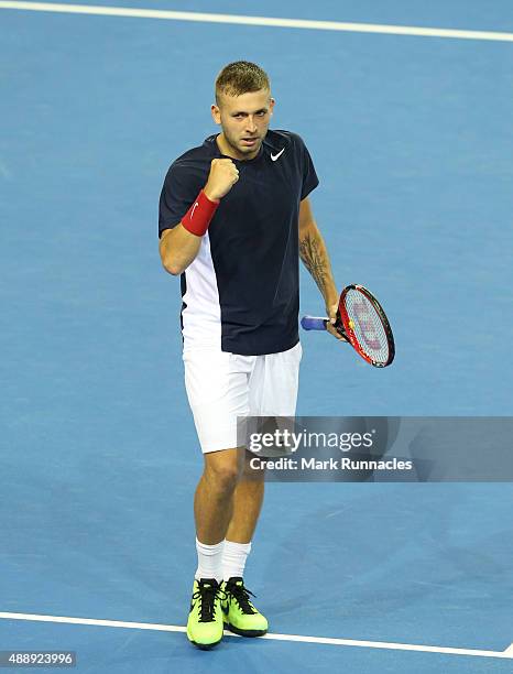 Dan Evans of Great Britain reacts after winning the 3rd set during his singles match with Bernard Tomic of Australia on the first day of the Davis...