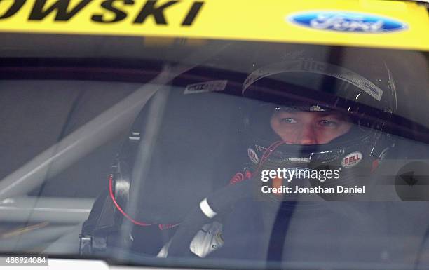Brad Keselowski, driver of the Miller Lite Ford, sits in his car during practice for the NASCAR Sprint Cup Series myAFibRisk.com 400 at Chicagoland...
