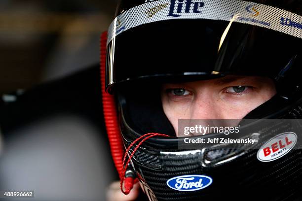 Brad Keselowski, driver of the Miller Lite Ford, sits in his car during practice for the NASCAR Sprint Cup Series myAFibRisk.com 400 at Chicagoland...