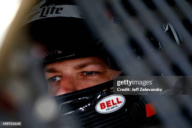 Brad Keselowski, driver of the Miller Lite Ford, sits in his car during practice for the NASCAR Sprint Cup Series myAFibRisk.com 400 at Chicagoland...