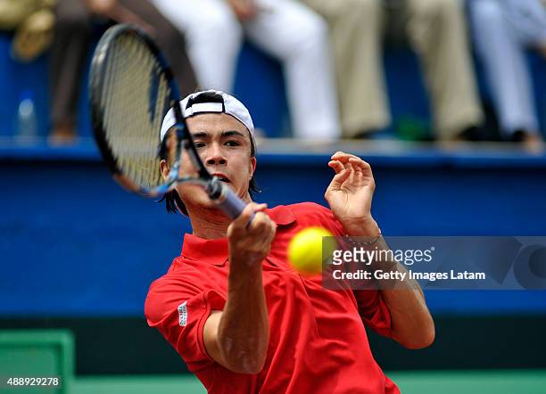 Taro Daniel of Japan returns a forehand shot during the Davis Cup World Group Play-off singles match between Santiago Giraldo of Colombia and Taro...