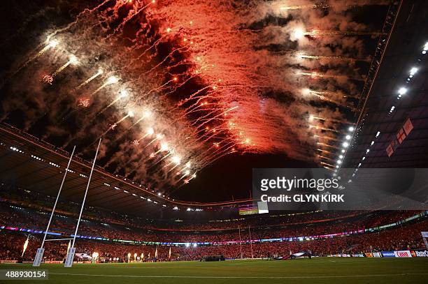 Attendees watch a fireworks show during the opening ceremony of the 2015 Rugby World Cup at Twickenham stadium in south west London on September 18,...