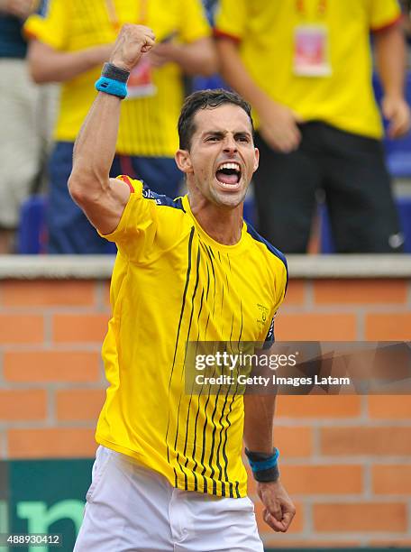 Santiago Giraldo of Colombia celebrates after defeating Taro Daniel of Japan during the Davis Cup World Group Play-off singles match between Santiago...