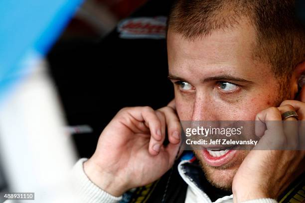 Brian Scott, driver of the Jewel-Osco/Kraft Singles Chevrolet, sits in his car during practice for the NASCAR Xfinity Series Furious 7 300 at...
