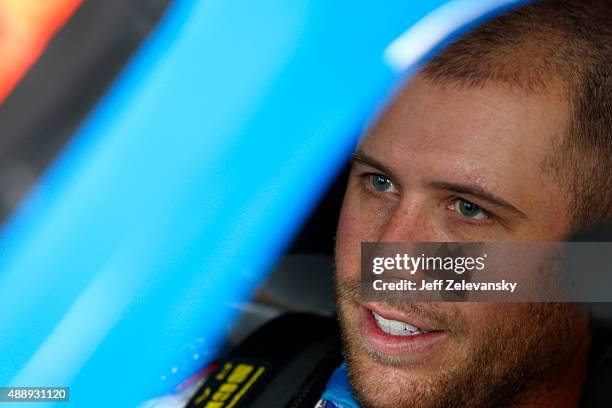 Brian Scott, driver of the Jewel-Osco/Kraft Singles Chevrolet, sits in his car during practice for the NASCAR Xfinity Series Furious 7 300 at...