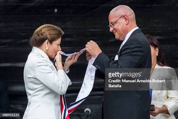Outgoing president Laura Chinchilla kisses the presidential sash at the Inauguration Day of Costa Rica's elected President Luis Guillermo Solis at...