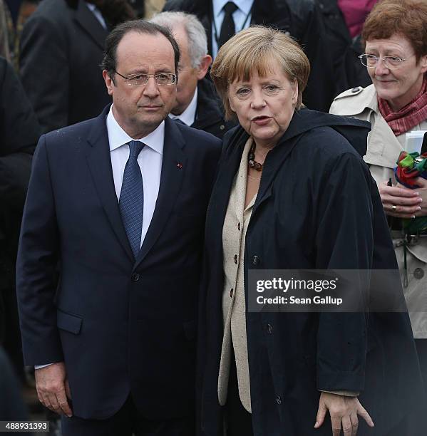 German Chancellor Angela Merkel and French President Francois Hollande arrive to board a boat to tour the nearby chalk cliffs on Ruegen Island on May...