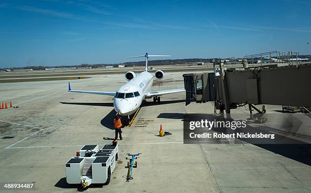 An United Express plane arrives at a docking bay April 18, 2014 at the Madison, Wisconsin airport. United Express is the regional branch of United...