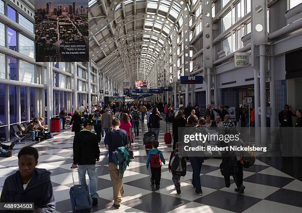 Traveling passengers walk to their flights April 18, 2014 at Chicago's O'Hare International Airport in Chicago, Illinois.