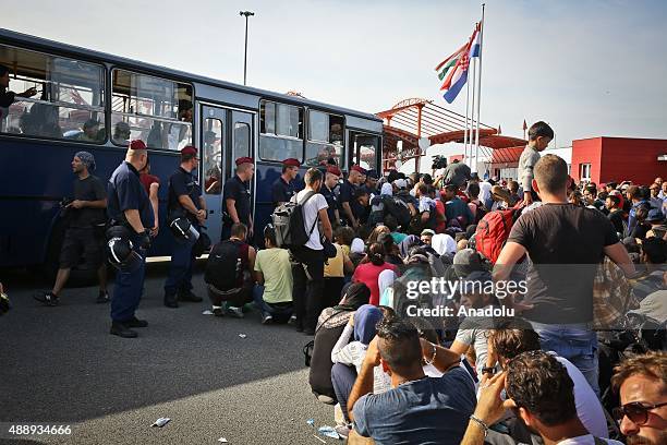 Refugees wait to get on the buses those will bring them to the Croatian village Baranysko Petrovo near Hungarian border, in Beli Manastir, in Croatia...