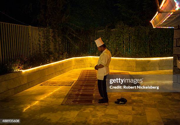 Chef prays in the evening September 3, 2015 at the Intercontinental Hotel in Kabul, Afghanistan.