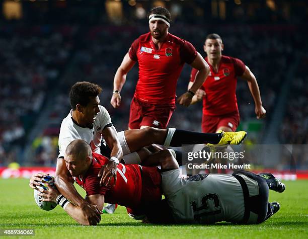 Ben Volavola and Metuisela Talebula of Fiji fail to stop Mike Brown of England scoring their third try during the 2015 Rugby World Cup Pool A match...