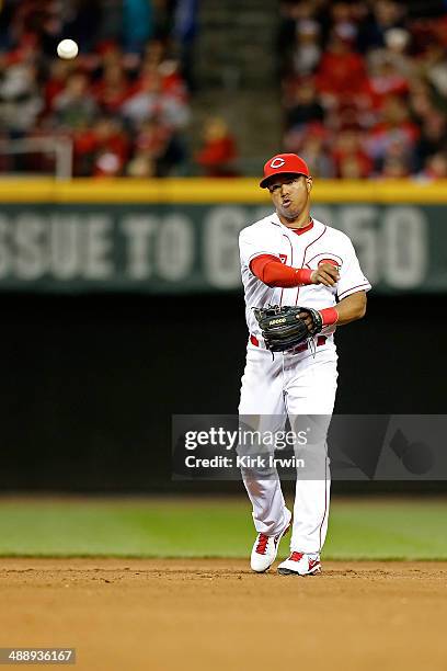 Ramon Santiago of the Cincinnati Reds warms up between innings during the game against the Milwaukee Brewers at Great American Ball Park on May 2,...