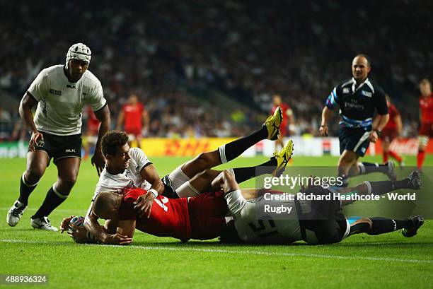 Ben Volavola and Metuisela Talebula of Fiji fail to stop Mike Brown of England scoring their third try during the 2015 Rugby World Cup Pool A match...