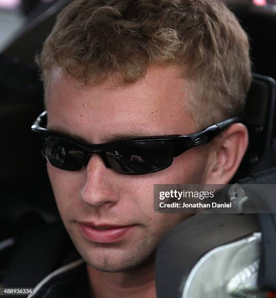 Caleb Roark, driver of the Driven2Honor.org Chevrolet, sits in his truck during qualifying for the NASCAR Camping World Truck Series American Ethanol...