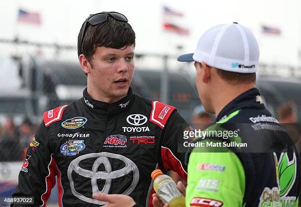 Erik Jones, driver of the Certified Used Vehicles Toyota, talks to Daniel Hemric, driver of the California Clean Power Chevrolet, on the grid during...
