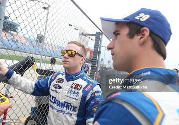 Tyler Reddick, driver of the Stoney Creek Records Ford, talks to Austin Theriault, driver of the Cooper Standard Ford, during qualifying for the...