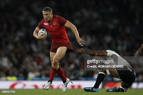 Fiji's number 8 Sakiusa Matadigo tackles England's centre Sam Burgess during a Pool A match of the 2015 Rugby World Cup between England and Fiji at...