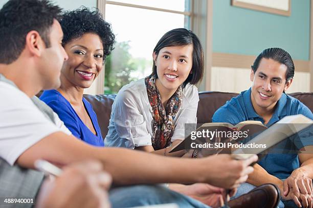 group of young adults having discussion during bible study - bible stock pictures, royalty-free photos & images