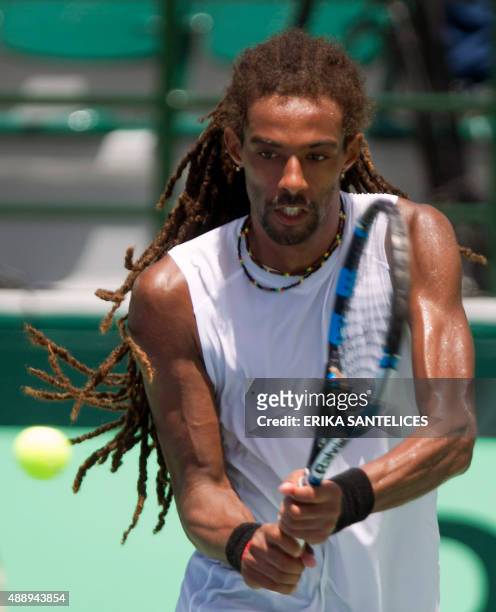 German tennis player Dustin Brown returns the ball to Dominican Victor Estrella during during their Copa Davis match in Santo Domingo on September...