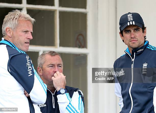 England coaches Peter Moores and Paul Farbrace stand with England captain Alastair Cook as they wait for conditions to improve during the One Day...