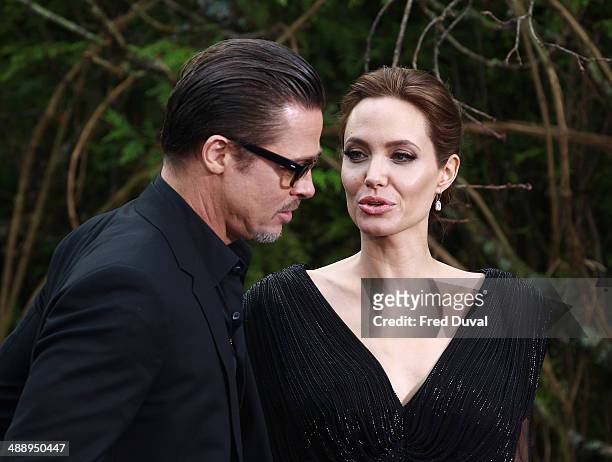 Brad Pitt and Angelina Jolie attend a private reception as costumes and props from Disney's "Maleficent" are exhibited in support of Great Ormond...