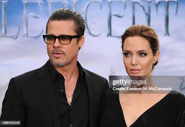 Brad Pitt and Angelina Jolie attend a private reception as costumes and props from Disney's "Maleficent" are exhibited in support of Great Ormond...