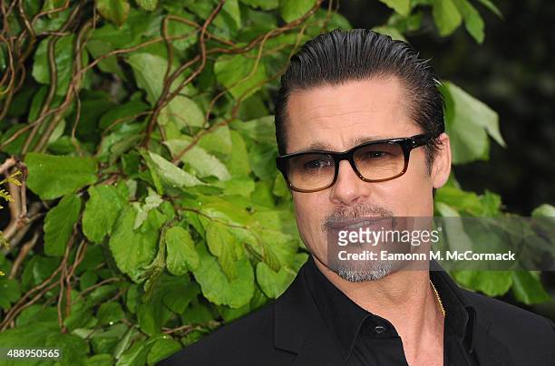 Brad Pitt attends a private reception as costumes and props from Disney's "Maleficent" are exhibited in support of Great Ormond Street Hospital at...