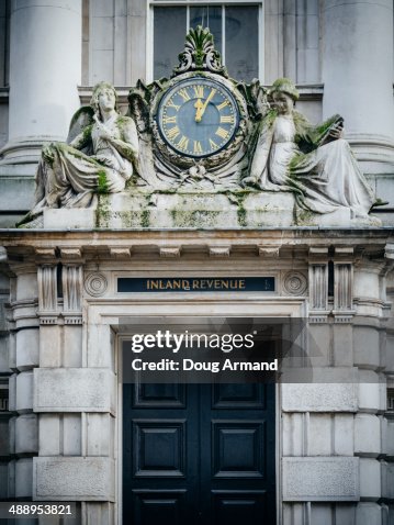 Inland Revenue sign and old clock Inland Revenue sign and old clock