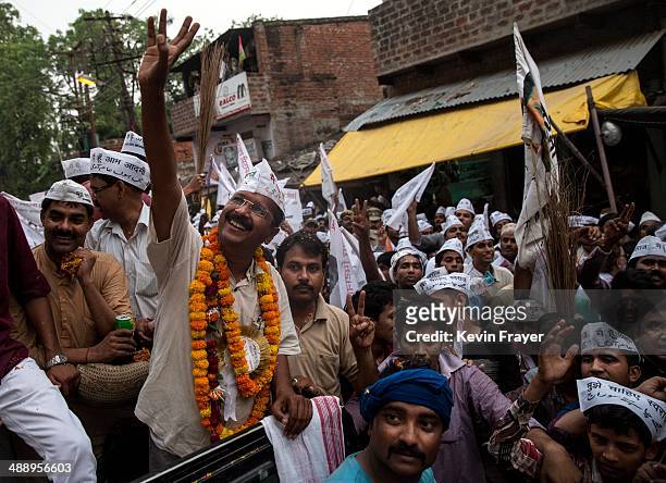 Leader Arvind Kejriwal waves to supporters during a rally by the leader on May 9, 2014 in Varanasi, India. India is in the midst of a nine-phase...