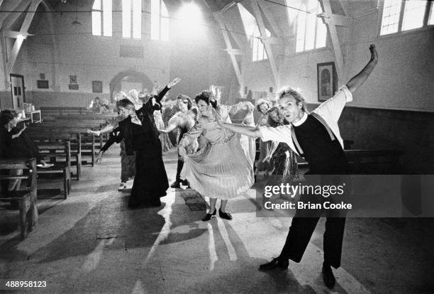 Sting performing while making a promotional film for his single Spread A Little Happiness from his album Brimstone and Treacle at a church hall in...