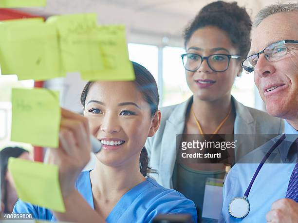 medical team brainstorming - group people thinking stock pictures, royalty-free photos & images