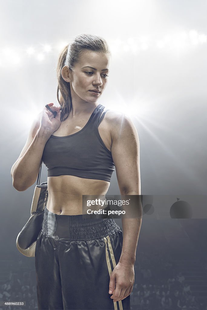 Female Boxer Holding Gloves