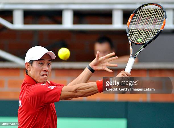 Kei Nishikori of Japan returns a backhand shot during the Davis Cup World Group Play-off singles match between Alejandro Falla of Colombia and Kei...