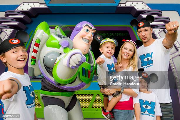 In this handout photo provided by Disney Parks, actress Melissa Joan Hart and husband singer-songwriter Mark Wilkerson , along with their sons Mason,...